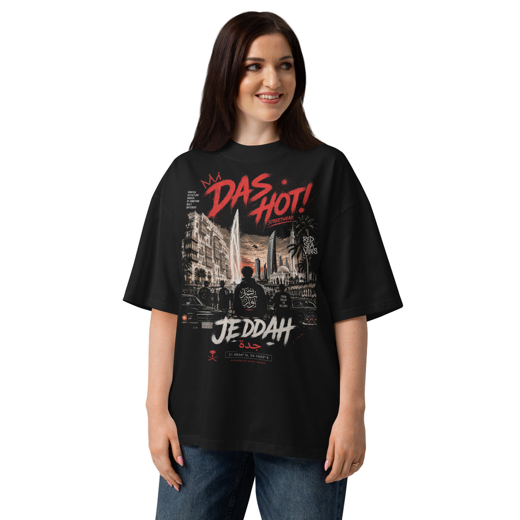 20-year-old_Arab_female_wearing_the_Das_Hot_Desert_Hype_Jeddah_Red_Sea_Vibes_oversized_black_streetwear_T-shirt_in_a_lifestyle_fashion_portrait_featuring_the_Jeddah_city_graphic_on_the_ front_front_view