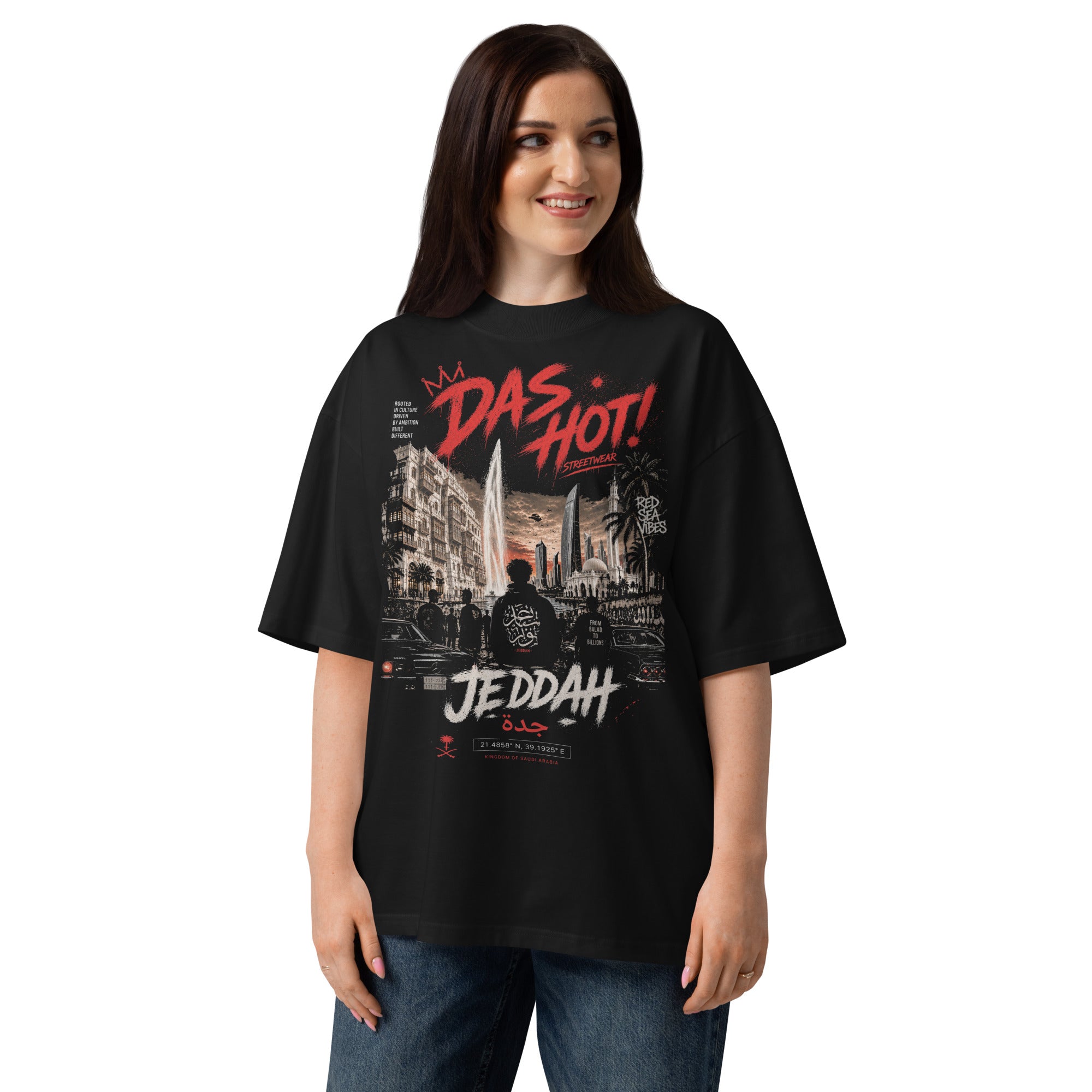 20-year-old_Arab_female_wearing_the_Das_Hot_Desert_Hype_Jeddah_Red_Sea_Vibes_oversized_black_streetwear_T-shirt_in_a_lifestyle_fashion_portrait_featuring_the_Jeddah_city_graphic_on_the_ front_front_view