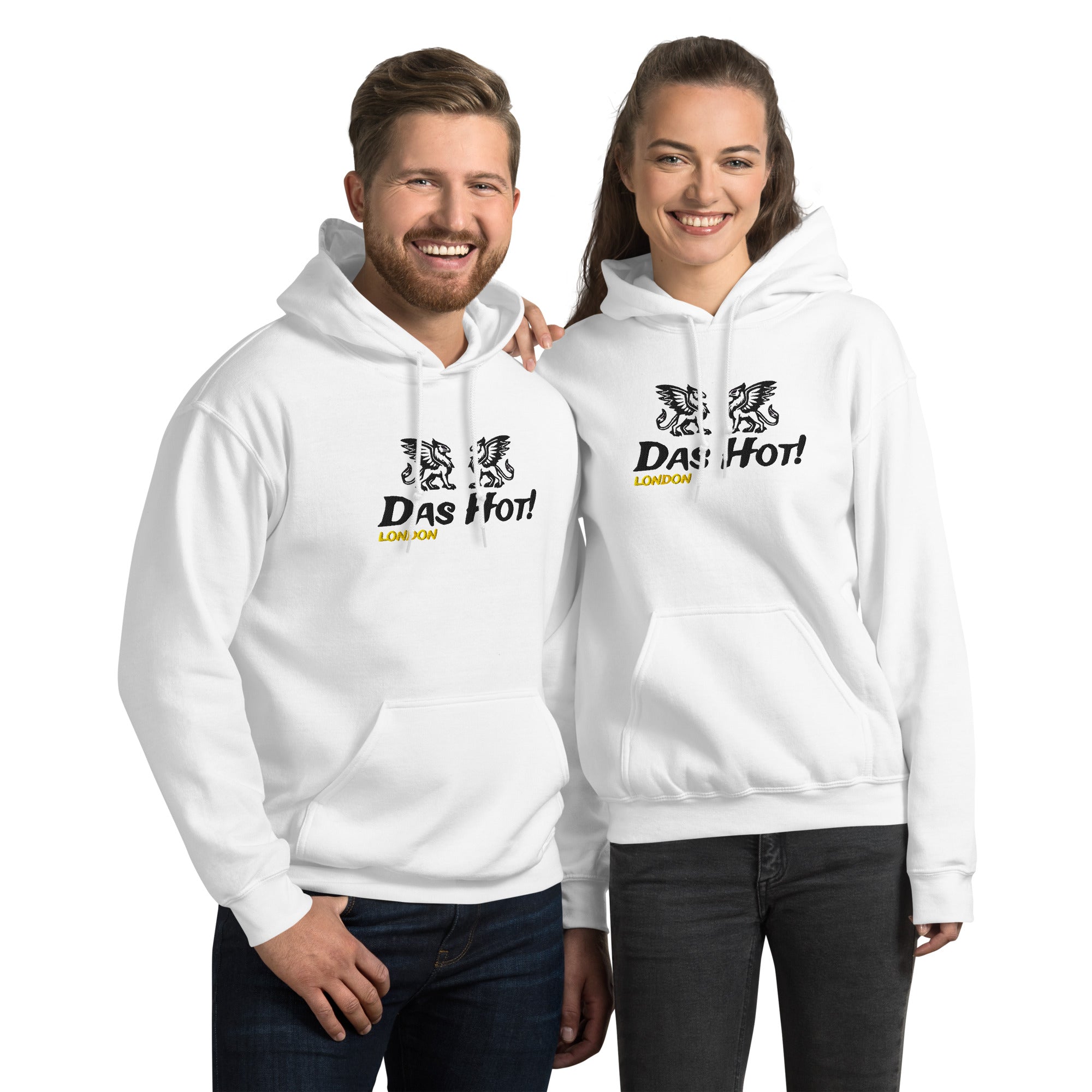 Front view of a male and female model standing together, showcasing the unisex fit of the premium white streetwear hoodie by Das Hot! London. Both hoodies feature high-density black raised embroidery of twin heraldic griffins and the Das Hot! brand name across the chest, with a contrasting yellow-gold embroidered London accent located directly underneath the brand name.