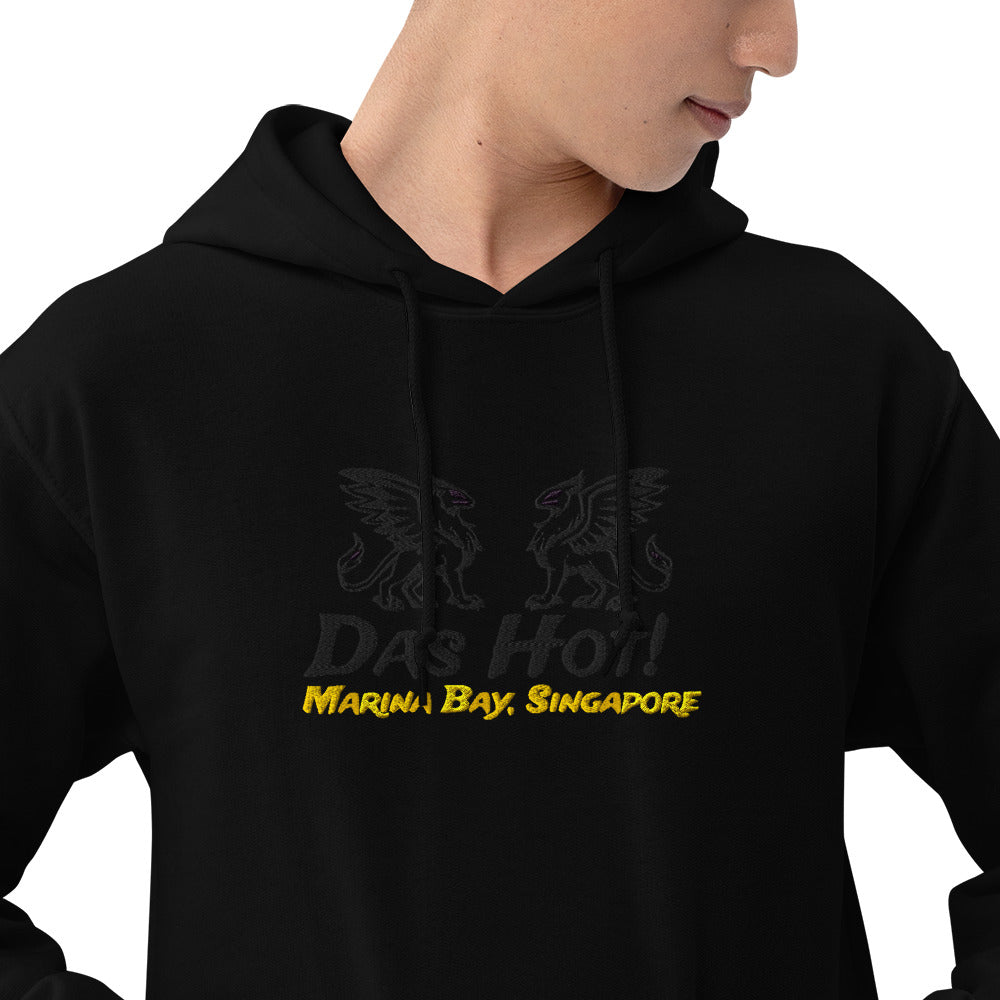 Side profile of male model wearing black unisex streetwear hoodie 8oz with tone on tone chest griffins and golden yellow Marina Bay Singapore embroidery
