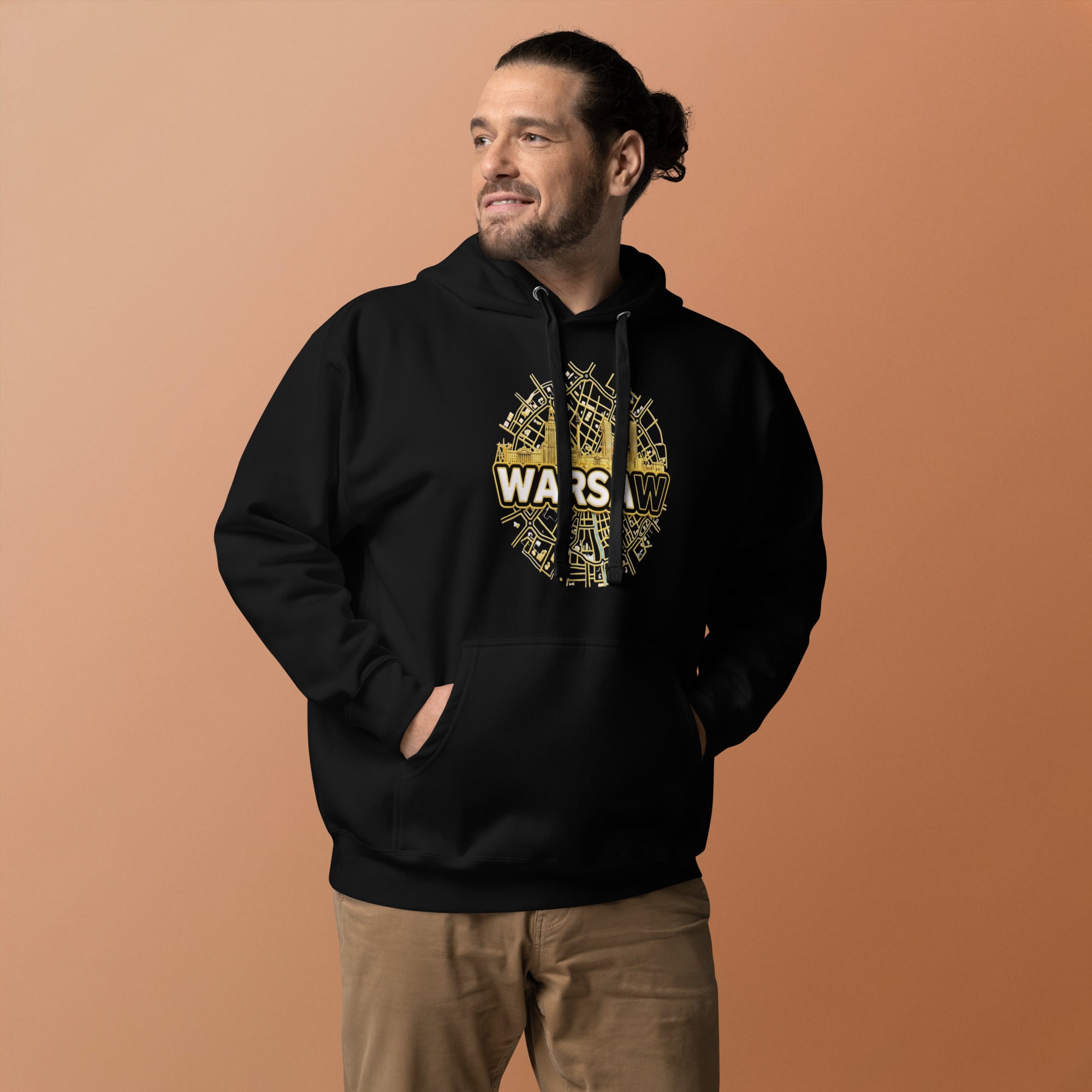 Man wearing a black hoodie with gold city of Warsaw design and text on a brown background