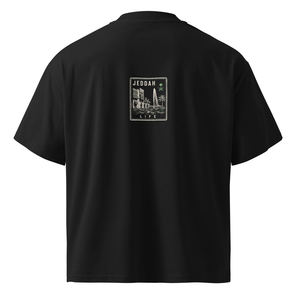 Back view of the Das Hot! Desert Hype Collection oversized black streetwear T-shirt featuring the Jeddah Life heritage badge inspired by Al-Balad architecture, King Fahd Fountain and Saudi Arabian culture.