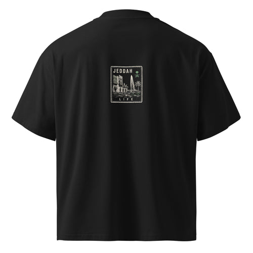 Back view of the Das Hot! Desert Hype Collection oversized black streetwear T-shirt featuring the Jeddah Life heritage badge inspired by Al-Balad architecture, King Fahd Fountain and Saudi Arabian culture.