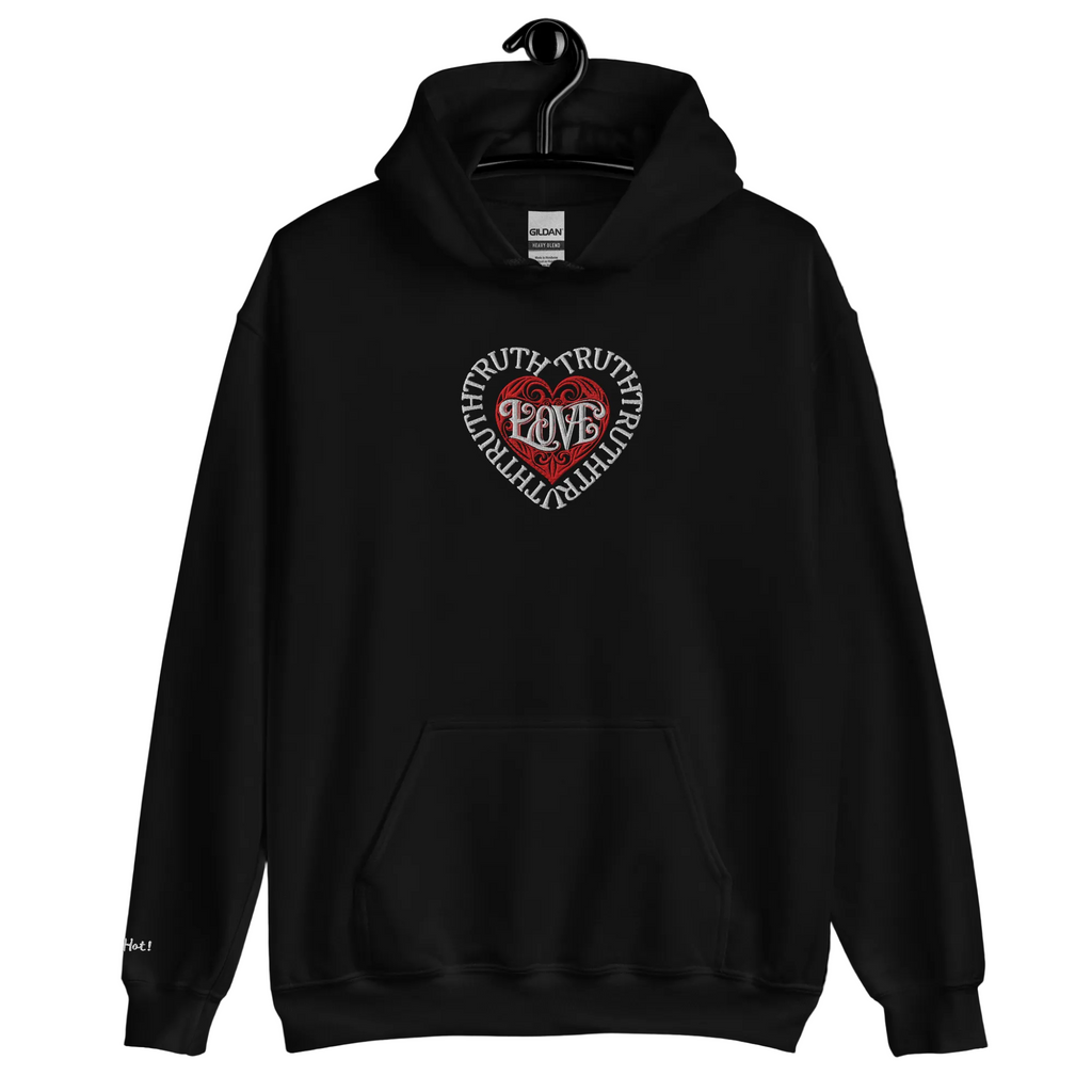 A ghost mannequin displays a front view of the solid black Dashot hoodie, showcasing the centralized white and red embroidered tribal heart shield with the brand name stitched subtly on the right wrist area.