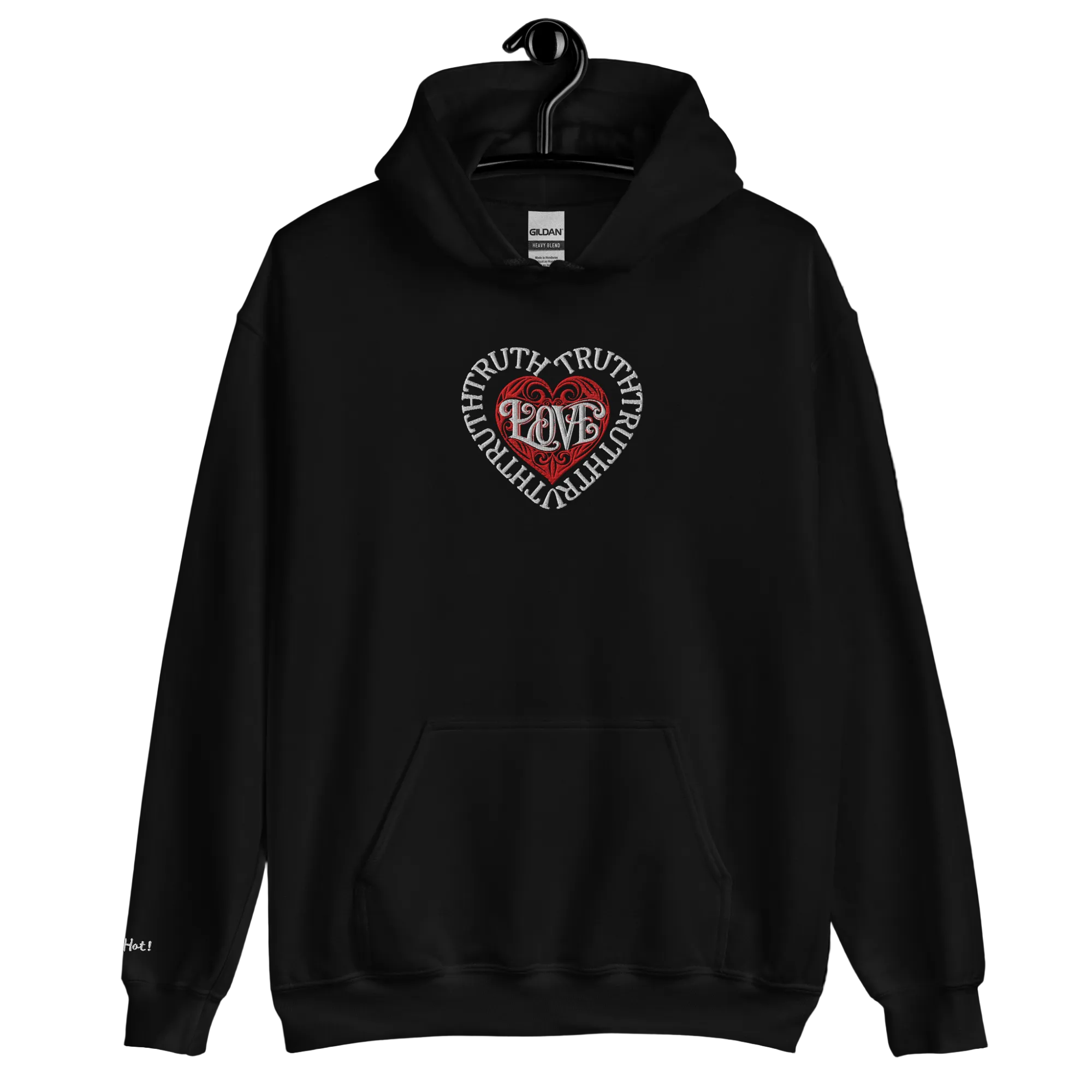 A ghost mannequin displays a front view of the solid black Dashot hoodie, showcasing the centralized white and red embroidered tribal heart shield with the brand name stitched subtly on the right wrist area.