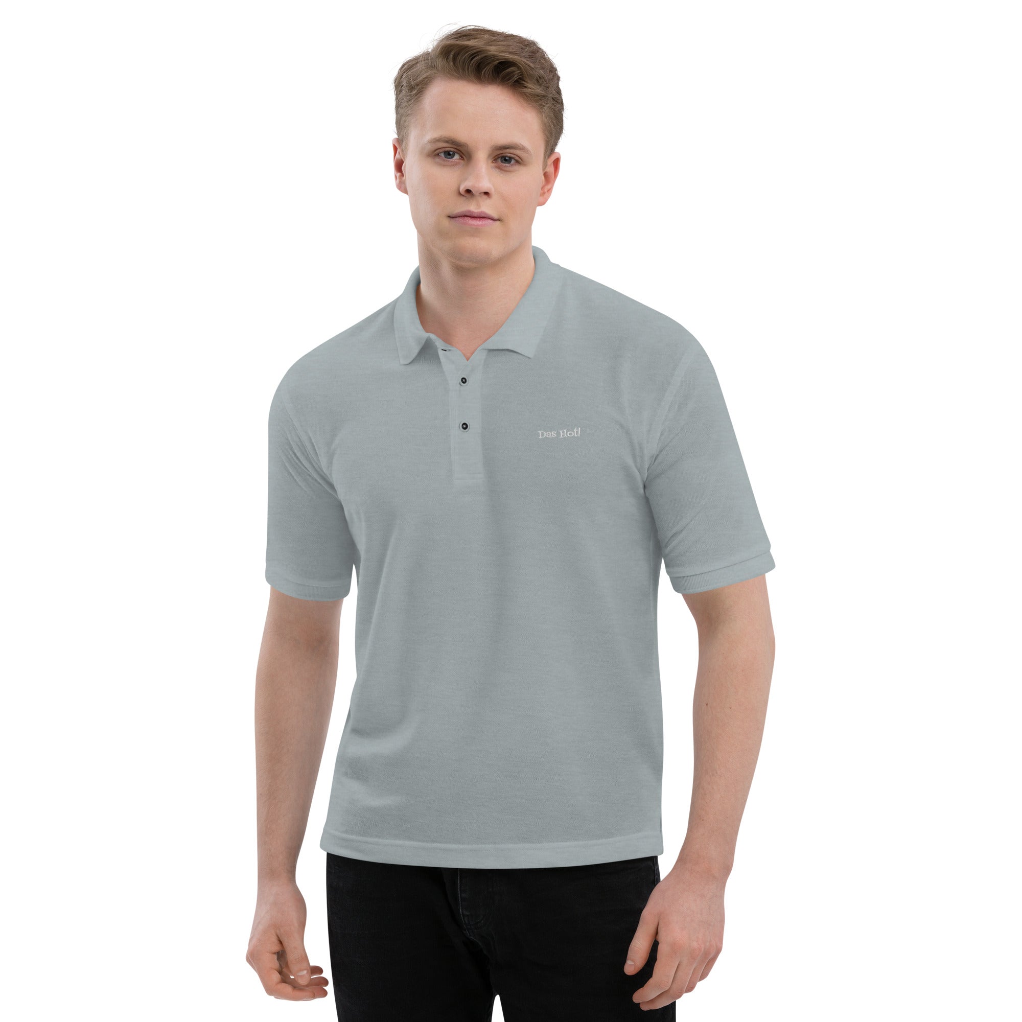 Man wearing a gray polo shirt with a logo on a white background