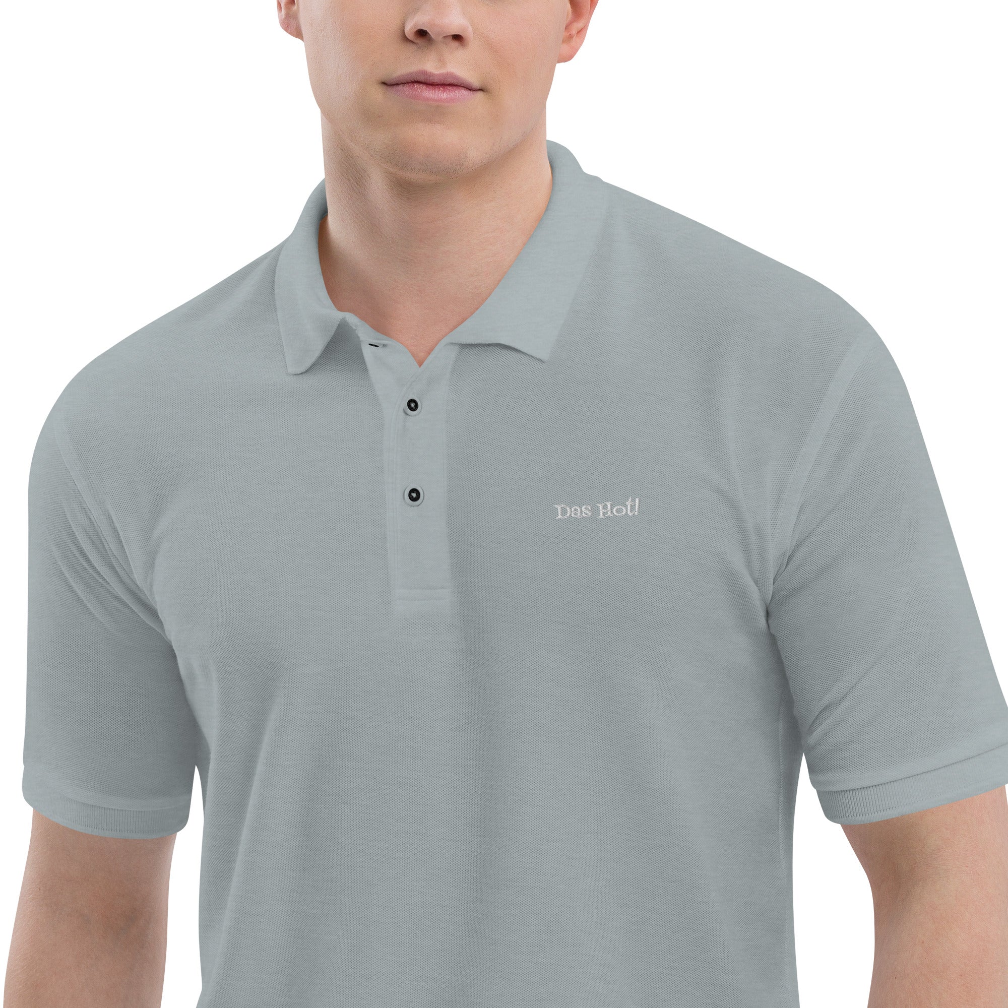 Gray polo shirt with 'Des Hoc' branding worn by a person on a white background